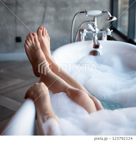 Woman feet in bathrobe at home, closeup 123792124