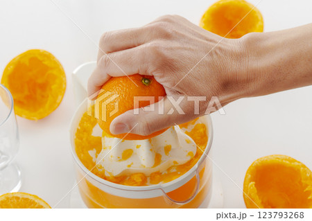 man making an orange juice man making an orange juice 123793268