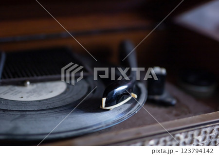 A detailed closeup of a record player featuring a vinyl record on it A detailed closeup of a record player featuring a vinyl record on it 123794142