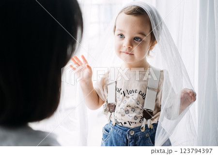 Bonding Through Simple Play Activities. Parent-child interaction, quality time, joyful moments, playing with curtains, strengthening relationships. Bonding Through Simple Play Activities. Parent-child interaction, quality time, joyful moments, playing with curtains, strengthening relationships. 123794397