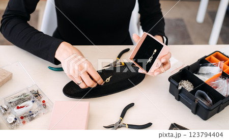 Handmade jewelry artisan packaging gold earrings for branding and sales. Indie jewelry designers, visual storytelling, creative entrepreneurship, product differentiation 123794404