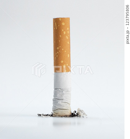 extinguished cigarette on a clean white surface extinguished cigarette on a clean white surface 123795806