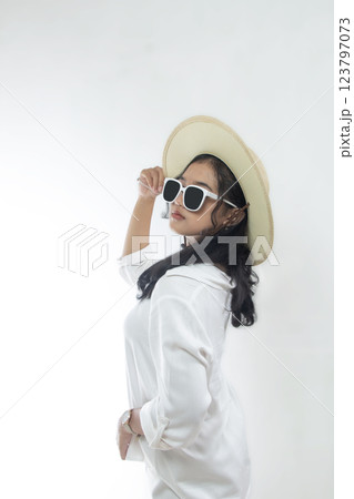 Portrait of beautiful young Asian woman in white casual clothes wearing straw hat and sunglasses isolated on white background. Summer vacation concept 123797073