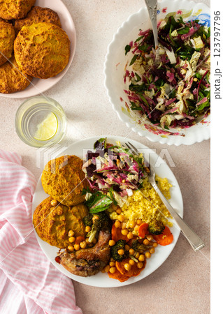 A filling, balanced breakfast with lentil and zucchini pancakes, millet, baked chicken neck, roasted sweet potatoes, broccoli, carrots, chickpeas, and a fresh salad with radish, sprouts, and nuts A filling, balanced breakfast with lentil and zucchini pancakes, millet, baked chicken neck, roasted sweet potatoes, broccoli, carrots, chickpeas, and a fresh salad with radish, sprouts, and nuts 123797796