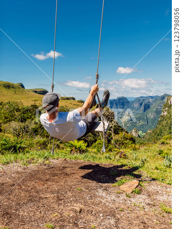 Man on swing in Espraiado Canyon park in Santa Catarina state, Brazil. Man on swing in Espraiado Canyon park in Santa Catarina state, Brazil. 123798056