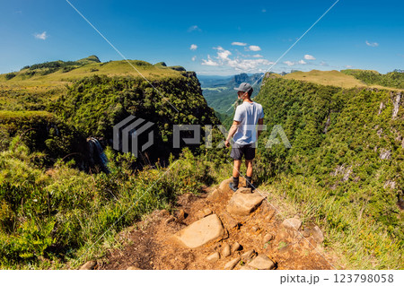 Traveller man staying on cliff in Espraiado canyon park in Santa Catarina, Brazil. 123798058