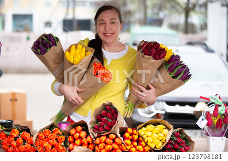 A woman with a bouquet of tulips. A flower seller at the market with bouquets on a pre-holiday day. 123798181