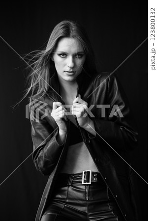 A Fashionable and Stylish Model Posing Confidently in a Chic Black Leather Outfit 123800132