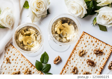Passover celebration composition with wine, matzah, white roses, and walnuts 123800225