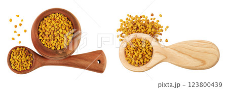 Bee pollen grains in wooden bowl and spoon isolated on white background. Top view. Flat lay Bee pollen grains in wooden bowl and spoon isolated on white background. Top view. Flat lay 123800439