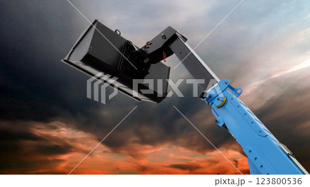 Telescopic boom lift bucket silhouetted against a colorful sunset sky with dramatic clouds Telescopic boom lift bucket silhouetted against a colorful sunset sky with dramatic clouds 123800536