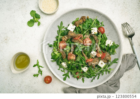 Warm beef meat salad with arugula 123800554