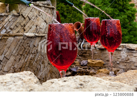 Fountain with red wine pouring from bottles Fountain with red wine pouring from bottles 123800888