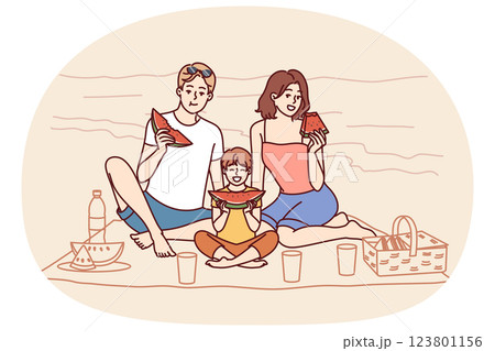 Family sitting on seashore, eating watermelon and relaxing on sunny beach in hot summer weather 123801156