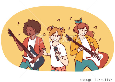Musical group of teenage girls with guitars and microphone performing at amateur concert 123801157