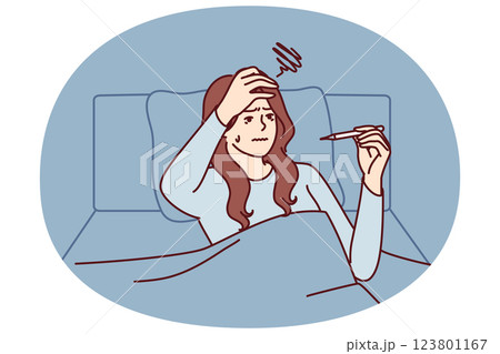 Sick woman with thermometer lies in bed under covers after being infected with viral infection flu 123801167