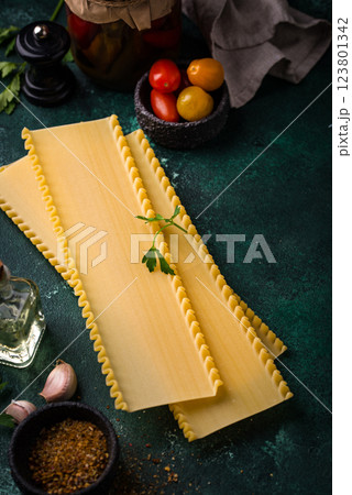 Uncooked lasagna pasta with cooking ingredient 123801342