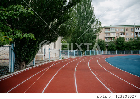 Red running sport track background and texture. Sport running track concept. Red running sport track background and texture. Sport running track concept. 123801627