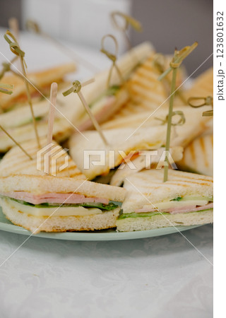 Triangular toast sandwiches with lettuce and ham on a plate Triangular toast sandwiches with lettuce and ham on a plate 123801632