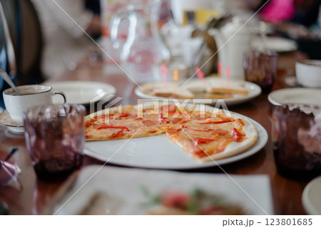 The served dinner table with pizza The served dinner table with pizza 123801685
