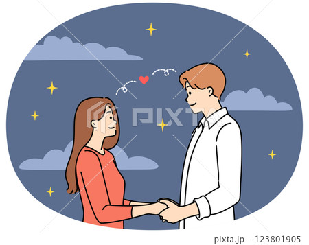 Happy couple holding hands under starry sky 123801905