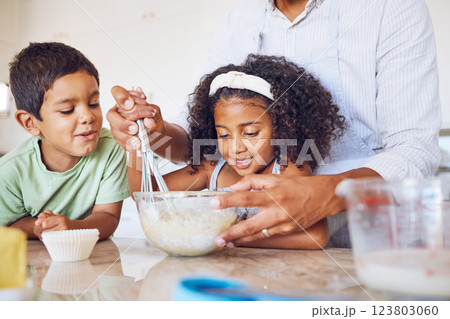 Happy family cooking, kitchen and mother with children learning to cook food or bake chocolate candy cupcake at home. Love, help and kids with baker mom have fun, bond or enjoy quality time together 123803060