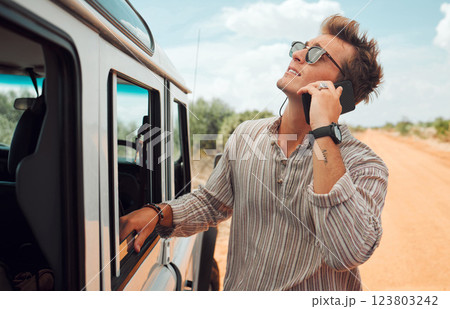 Phone, road trip and vehicle breakdown with a man on a call for roadside assistance while on holiday or vacation in the desert. Transport, stranded and alone with a young male calling for help 123803242