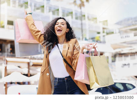 Retail, shopping and bags with woman in city for fashion, summer and gift for rich lifestyle. Luxury, sales and wow with happy girl customer in street with present from store, boutique or service 123803380