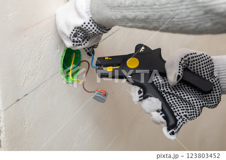 Installing electrical wiring during construction. Installing electrical wiring during construction. 123803452