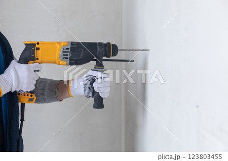Perforator in the business of drilling the wall. Perforator in the business of drilling the wall. 123803455
