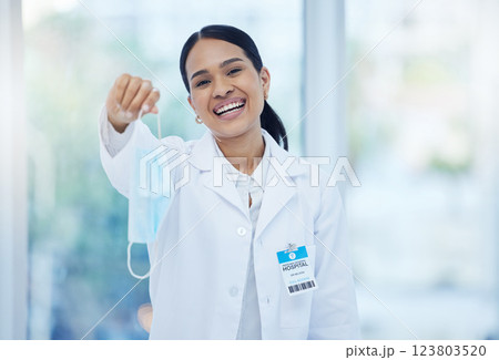 Doctor, covid end and smile of a woman healthcare employee in a hospital or clinic holding a mask. Portrait of a medical professional and consultant from Guatemala happy to after corona safety 123803520