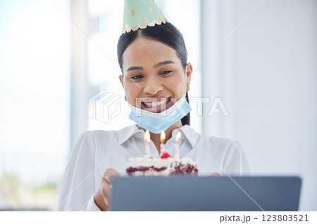 Woman in covid, video call birthday party and online celebration with candles on cake for social distancing at work. Coronavirus pandemic, face mask for global health and safety office compliance 123803521