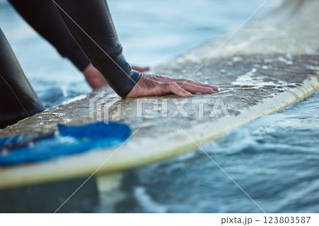 Surf, ocean surfing and hand of man on surfboard in sea water. Summer water sport fitness, male healthy lifestyle and outdoor wellness exercise and relax beach travel vacation in Hawaii 123803587