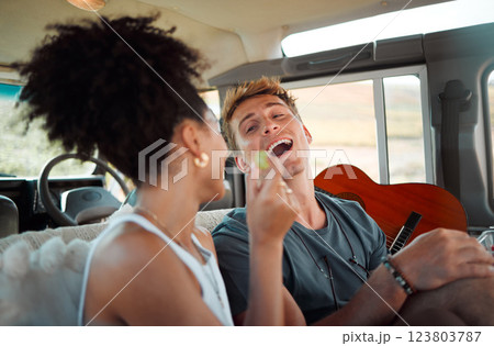 Couple eating on road trip, people travel in car with friends and vacation in Canada together. Black woman giving grape to boyfriend, funny man with open mouth and interracial love in camper drive Couple eating on road trip, people travel in car with friends and vacation in Canada together. Black woman giving grape to boyfriend, funny man with open mouth and interracial love in camper drive 123803787