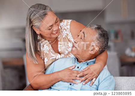 Hug, love and senior couple with smile for funny story while in the living room of their house. Happy, comic and elderly man and woman relax and hugging for support in the lounge of their home Hug, love and senior couple with smile for funny story while in the living room of their house. Happy, comic and elderly man and woman relax and hugging for support in the lounge of their home 123803895