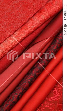 A collection of rich red fabrics showcasing various textures and patterns. 123805396