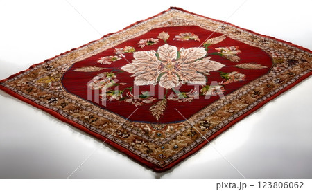 A red and brown carpet with a flower design 123806062