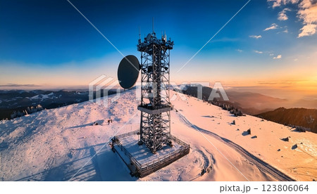 A tall tower with a satellite dish on top 123806064