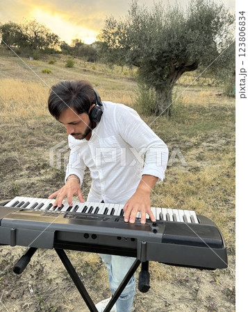 Boy Plays Keyboard In Nature In Calabria Countryside Boy Plays Keyboard In Nature In Calabria Countryside 123806834
