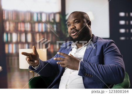 Confident entrepreneur strategize his business over whiskey in a luxury social club, representing diversity and the sophisticated old money fortune. Businessmen negotiating for a collaboration. 123808164