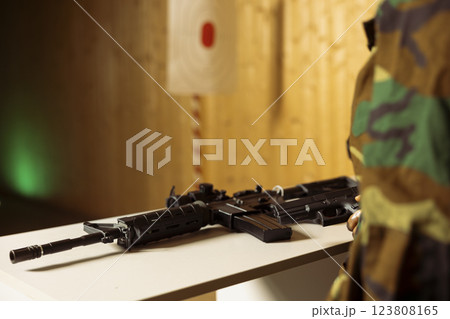 Army soldier doing intensive shooting course designed to elevate individual skills beyond basic marksmanship. Close up of rifle used to engage targets of different sizes at various ranges 123808165