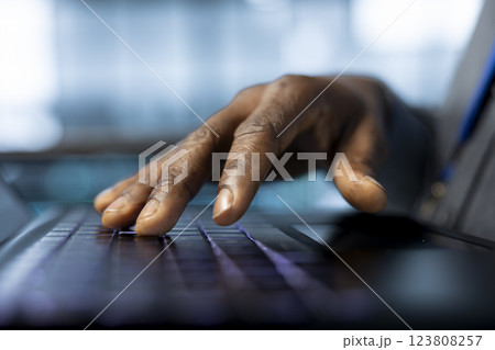 Technician in data center typing on laptop keyboard, developing disaster recovery plans. Close up of worker in server hub testing failover scenarios using notebook, protecting data during disruptions Technician in data center typing on laptop keyboard, developing disaster recovery plans. Close up of worker in server hub testing failover scenarios using notebook, protecting data during disruptions 123808257