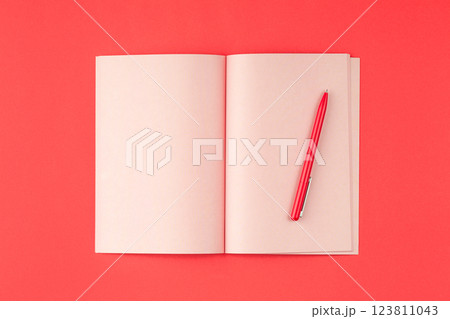 Pink notepad on a red background. Pink notepad on a red background. 123811043