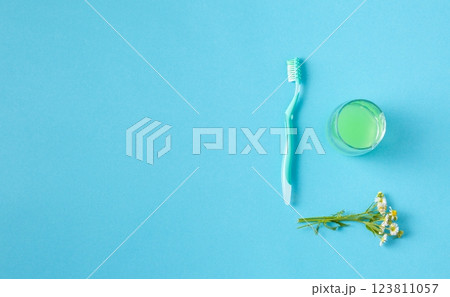 Mouthwash in a glass and a toothbrush. 123811057