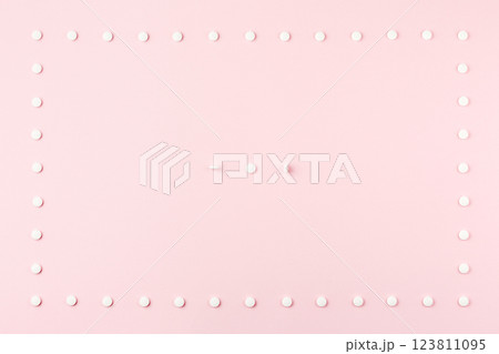 Pills on a pink table. 123811095