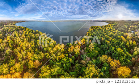 Autumn forest on lake shore at sunset and city on horizon, auerial view Autumn forest on lake shore at sunset and city on horizon, auerial view 123812518