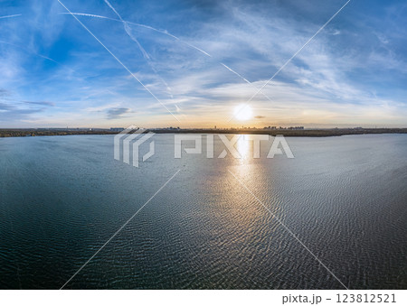 Autumn forest on lake shore at sunset and city on horizon, auerial view 123812521