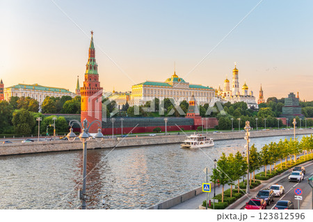 View of Kremlin with Vodovzvodnaya tower, Grand Kremlin Palace from repaired Bolshoy Kamenny Bridge in Moscow city on sunny summer day. Cruise ship sails on the Moscow river View of Kremlin with Vodovzvodnaya tower, Grand Kremlin Palace from repaired Bolshoy Kamenny Bridge in Moscow city on sunny summer day. Cruise ship sails on the Moscow river 123812596