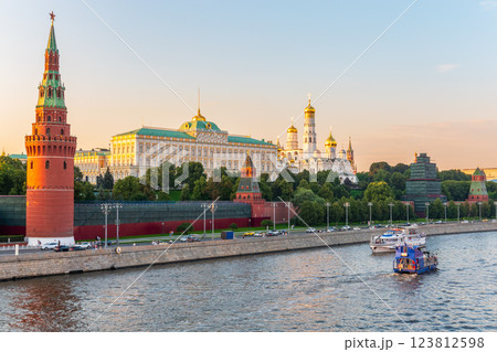 View of Kremlin with Vodovzvodnaya tower, Grand Kremlin Palace from repaired Bolshoy Kamenny Bridge in Moscow city on sunny summer day. Cruise ship sails on the Moscow river 123812598