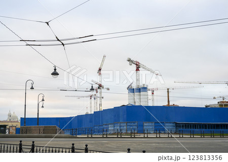 Industrial landscape with cranes, lanterns and tram wires against the sky of St. Petersburg, Russia 123813356